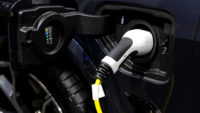 Close-up of charging cable plugged into the side of electric car