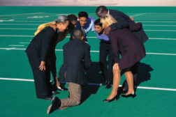 employees tennis court huddle