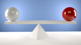 weighing a white ball and a red ball against each other